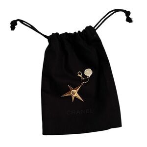 CHANEL Gold Star & small Camellia key Charm with black drawstring pouch.